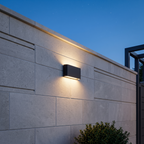 Atelierée black outdoor wall light casting twin beams at night