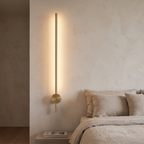 Atelierée Lacerva brass bathroom wall sconce beside a vanity mirror