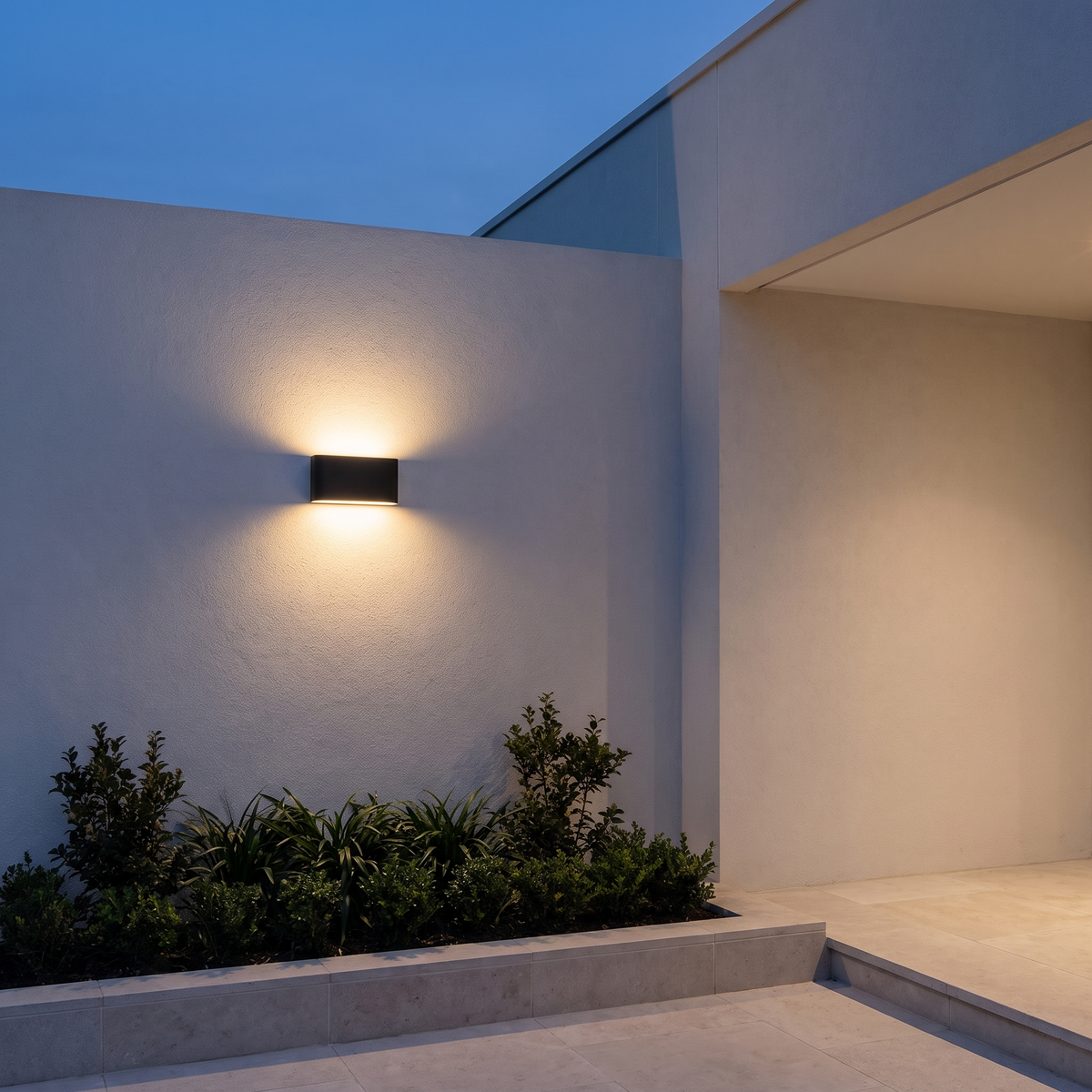Atelierée Porto up and down garden wall light at dusk