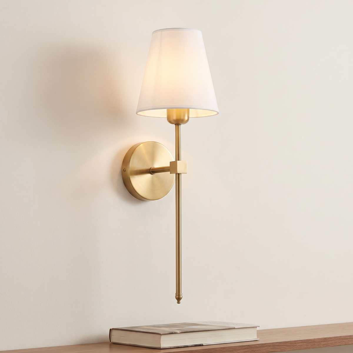 Atelierée Halston brass wall light shown above a shelf for scale