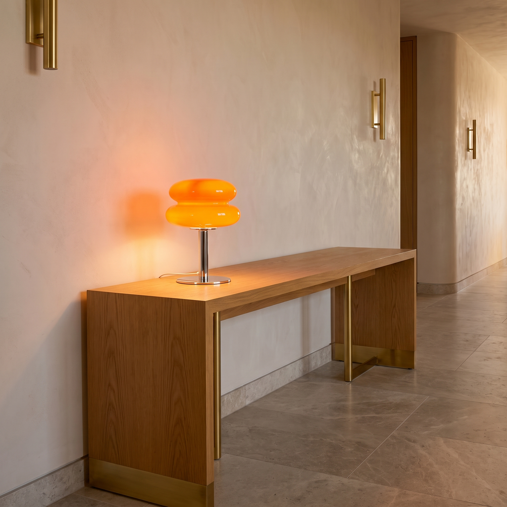 Italian designer glass table lamp lit on an oak console in a hallway