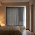 Self adhesive blackout curtain fitted across a bedroom window