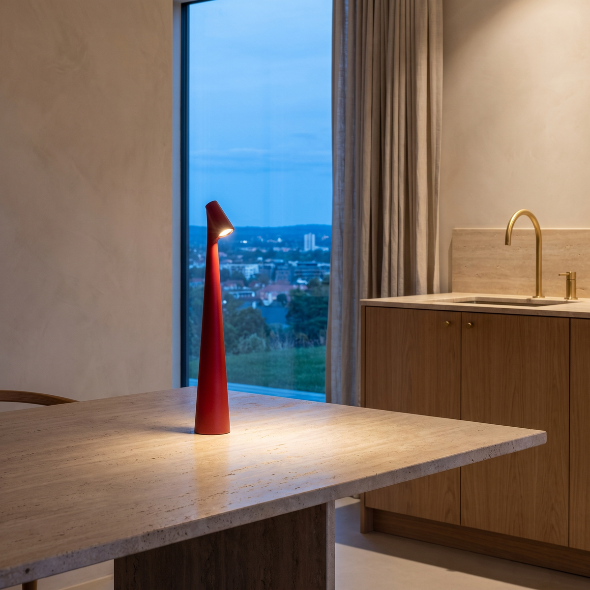 Cordless rechargeable LED table lamp lit on a dining table