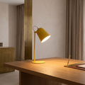 Nordic metal LED desk lamp lit on an oak desk