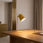 Nordic metal LED desk lamp lit on an oak desk
