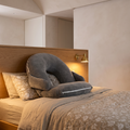 Folding U shape adjustable reading pillow against a bed headboard