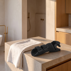 Compression wrist support brace on a honed stone counter beside a folded white towel
