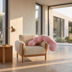 Oversized plush dinosaur body pillow slumped in a deep boucle armchair in a bright sitting room