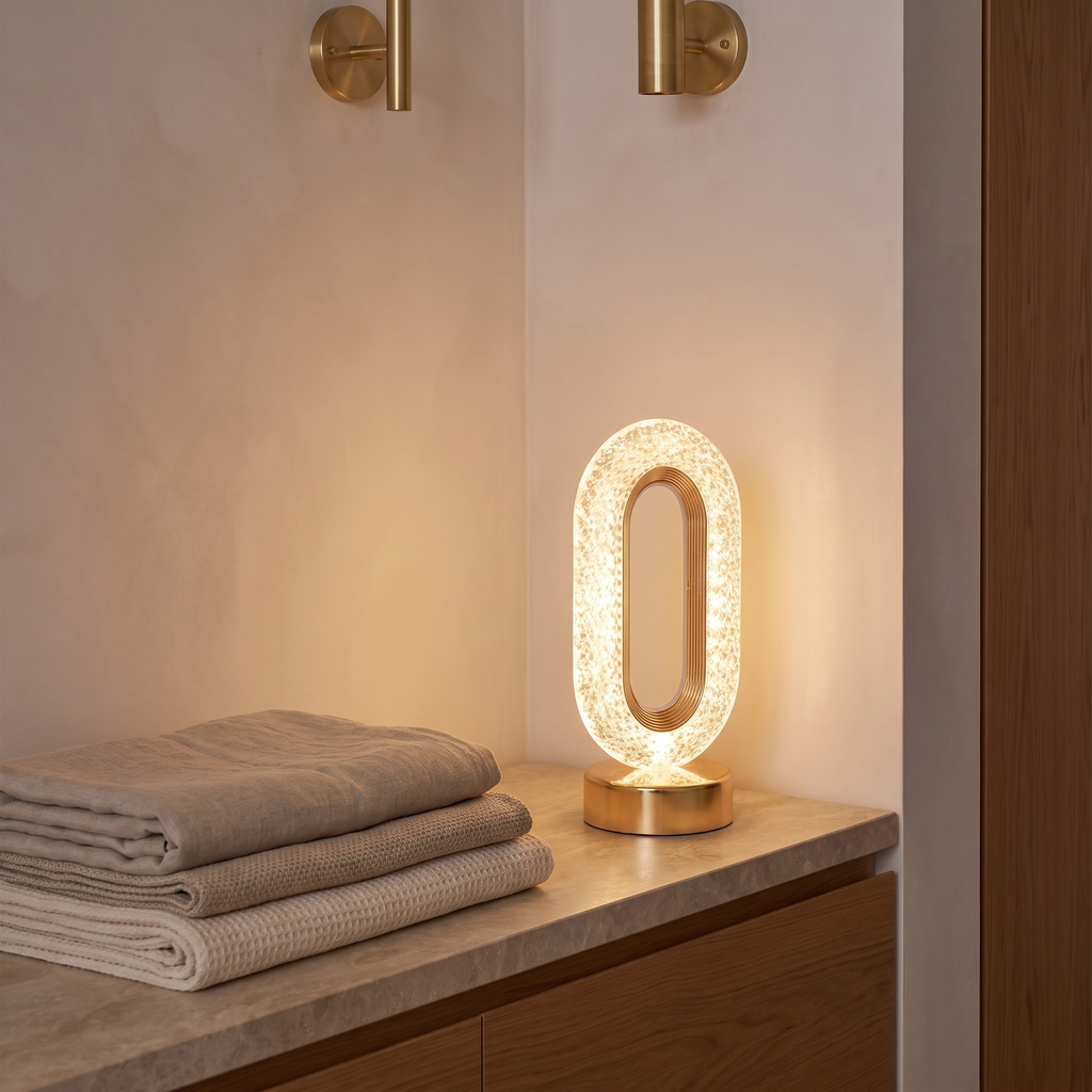 3D crystal LED night light on a bedside table beside folded linen