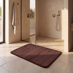 Anti slip fast dry bathroom rug on stone flooring beside a glass walk in shower