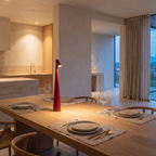 Cordless rechargeable LED table lamp on a laid oak dining table set for dinner
