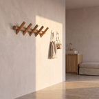 Solid oak wall rack with hooks on a plaster utility room wall with a canvas tote hanging from it
