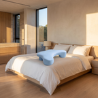 Side sleeper pillow with an arm hole on a neatly made linen bed in a quiet bedroom