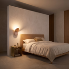 Minimalist LED wall lamp mounted on a plaster wall beside the head of a low bed