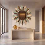 Teal and gold sunburst wall mirror on a plaster wall above a travertine console table