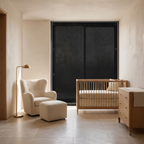 Magnetic no drill blackout window shade fitted over a nursery window, the room dim behind it