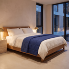 Breathable weighted cooling blanket folded across the end of a linen bed