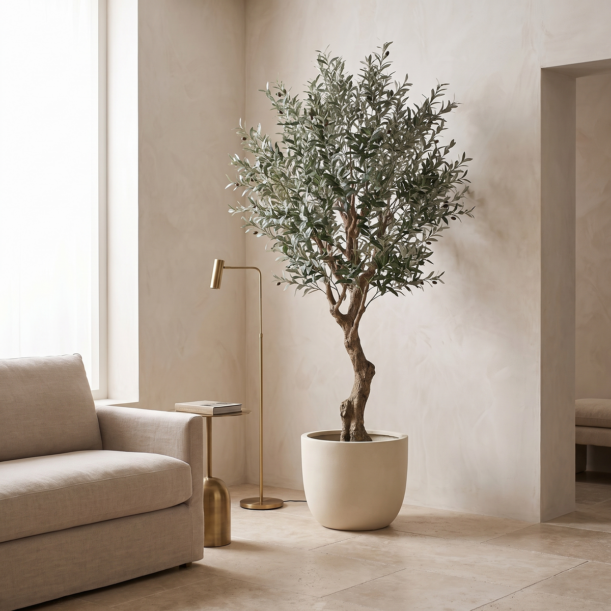 Artificial olive tree in the corner of a living room with a travertine floor