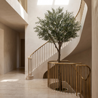 Tall 240cm artificial olive tree in a double height hallway beside a staircase