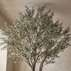 Looking up into the canopy of a tall artificial olive tree