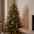 Pre lit artificial Christmas tree beside a honed stone fireplace