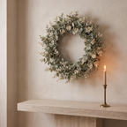 Eucalyptus wreath hung above a stone console with a brass candlestick