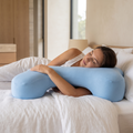 Atelierée side sleeper pillow in use with the arm through the opening