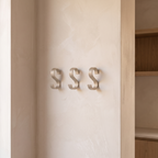 Multipurpose aluminium hooks fitted in a row on a wall