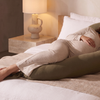 Close detail of the pregnancy pillow supporting the bump and knees
