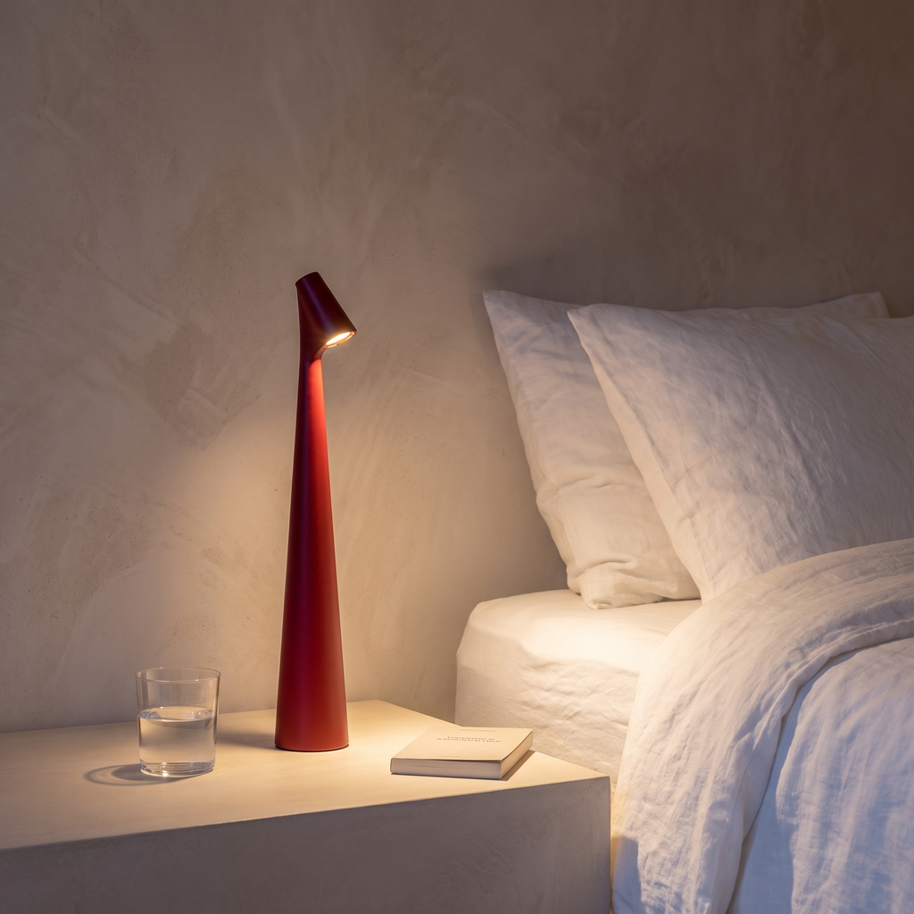 Glowora rechargeable table lamp glowing on a bedside table