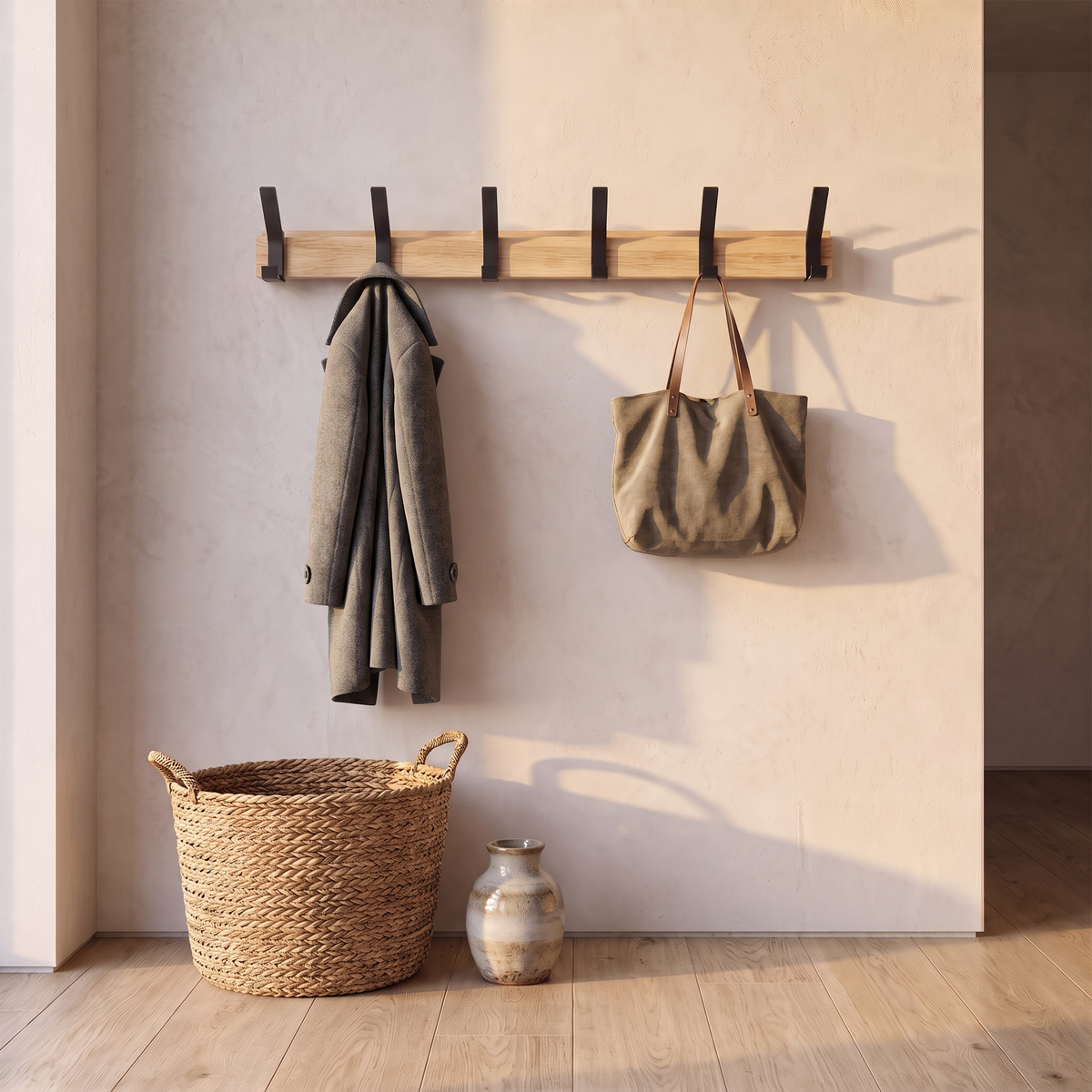 Nordic wall mounted coat rack in use with a coat and bag hanging