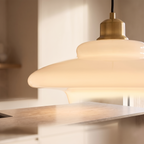 Close detail of the white glass pendant shade and fitting