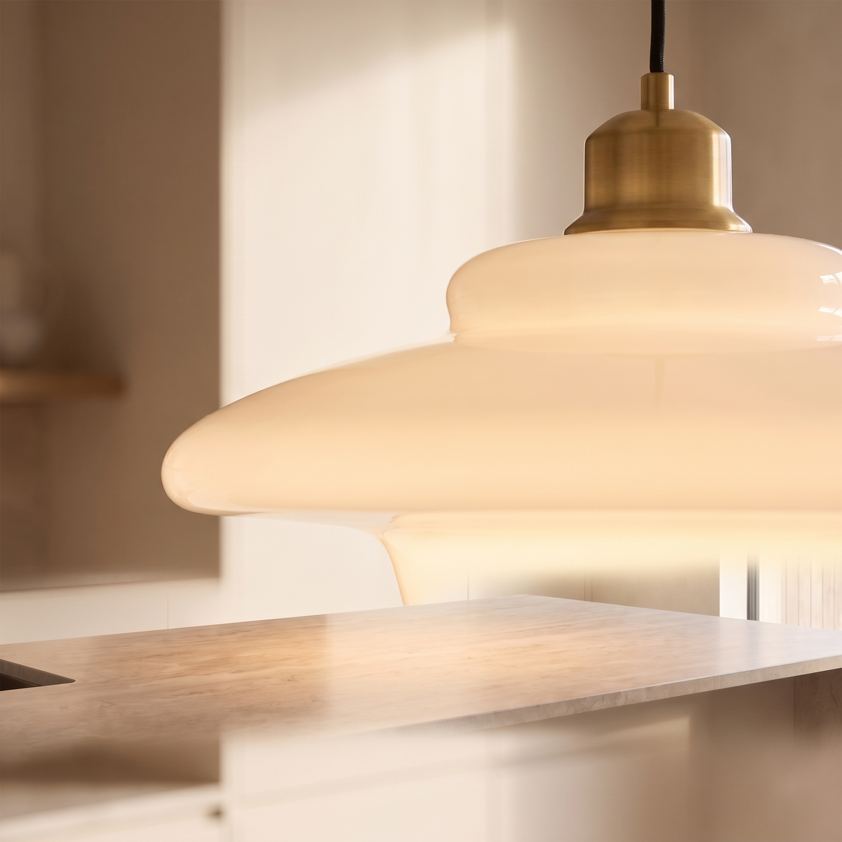 Close detail of the white glass pendant shade and fitting