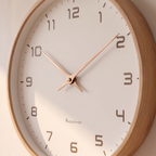 Close detail of the wall clock wood frame and hands