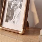 Close detail of the photo frame wood grain and brass detail