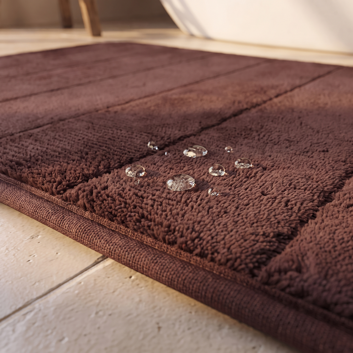 Close detail of the bath mat pile texture and edge binding