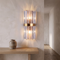 Crystal wall light mounted in a hallway above a console table