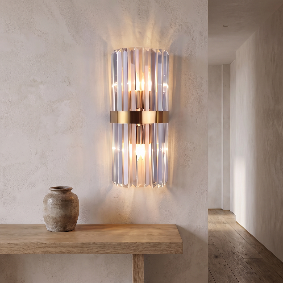 Crystal wall light mounted in a hallway above a console table