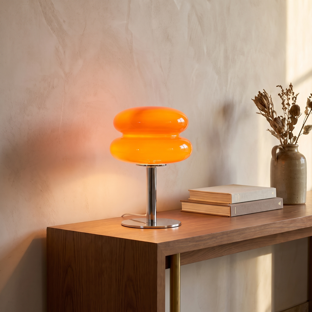 Italian designer glass table lamp lit on a living room console