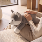 Close detail of hands resting on the weighted plush toy
