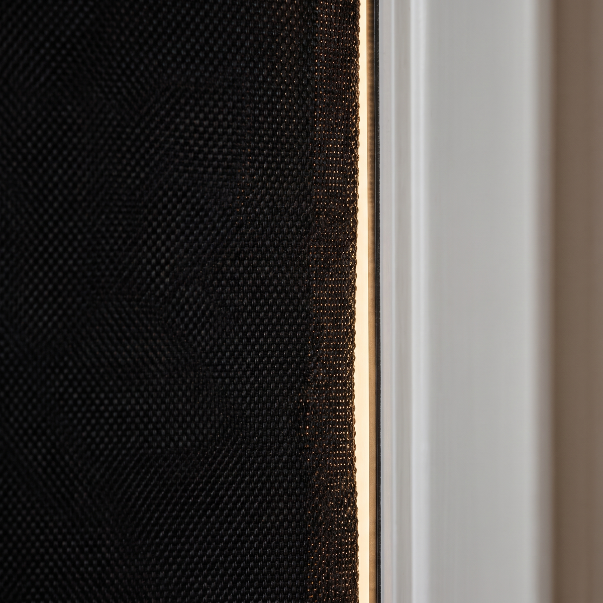 Close detail of the blackout shade magnetic edge against the window frame