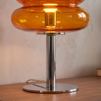 Close detail of the glass table lamp form and base join