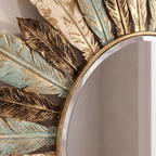 Close detail of the sunburst mirror leaf metalwork and glass edge