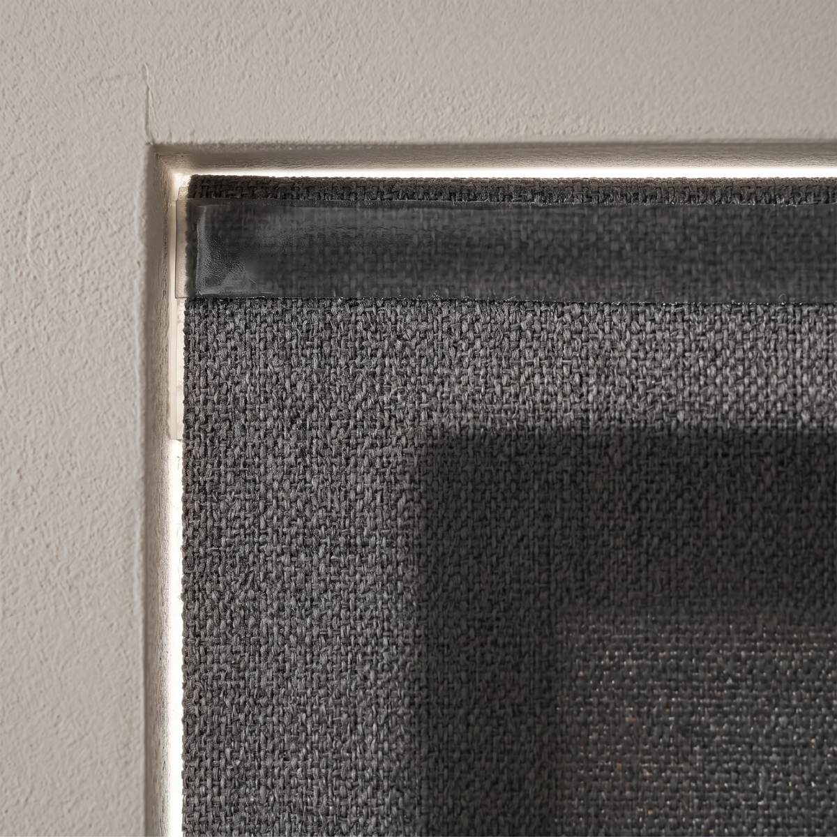 Close detail of the blackout blind adhesive strip at the window frame