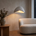 Zenith Glow pendant light beside a living room sofa