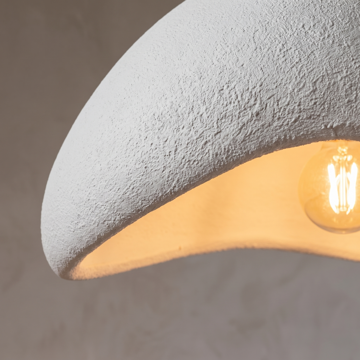 Close detail of the handmade textured shade and warm glow