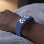 Close detail of the alarm watch worn on the wrist