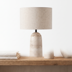 Armine travertine table lamp on a plain white background