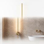 Lacerva brushed brass wall light on a plain white background