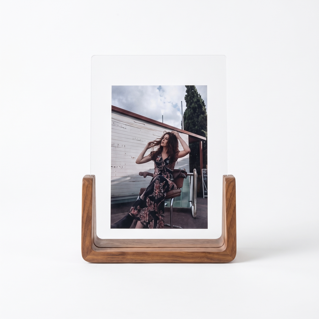 U shaped acrylic and wood photo frame on a plain white background